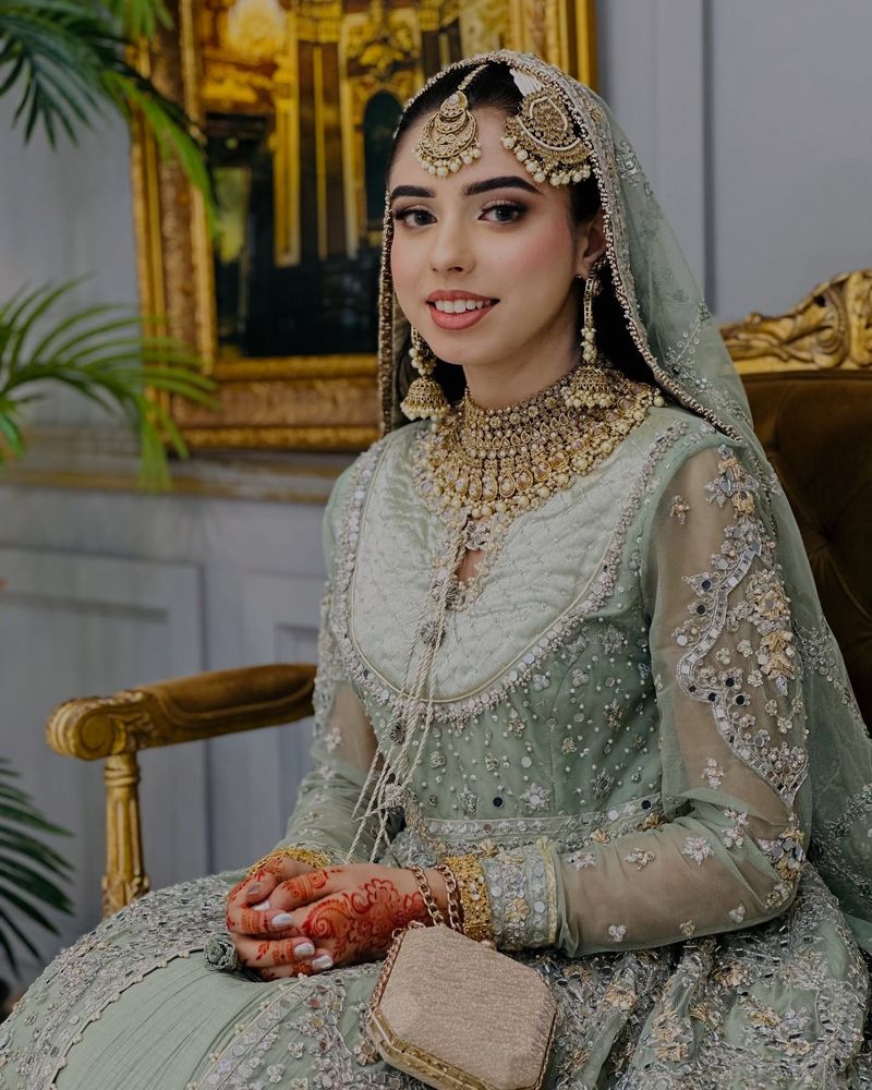 Bridal client in sage-green embellished outfit with traditional jewellery