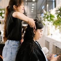 Hair styling in progress at a NUMRA studio